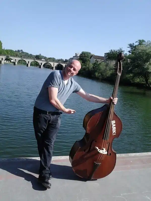 Jason Barnard holding his double bass in Leeds