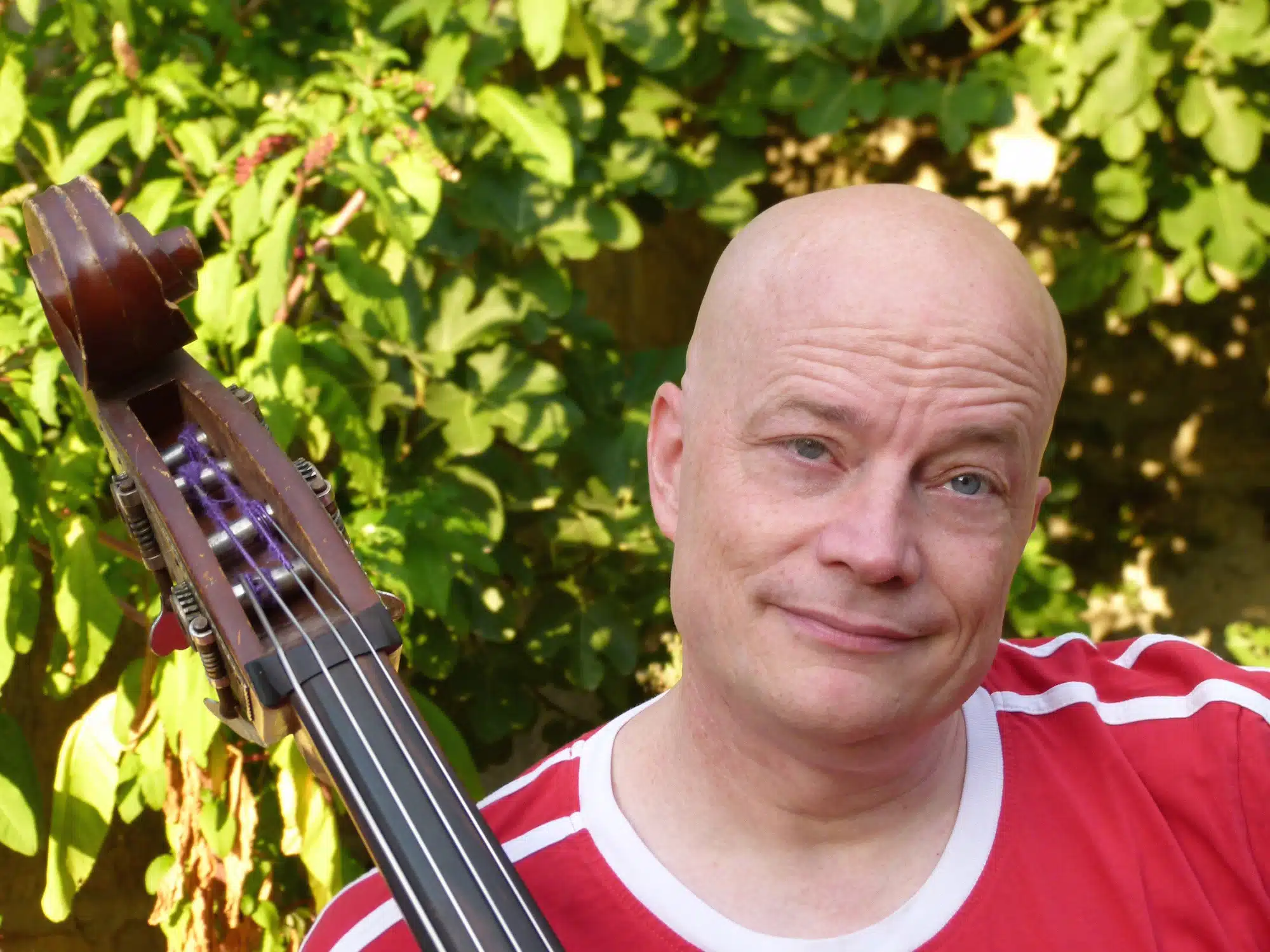 Jason Martin Barnard in red shirt with double bass